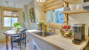 A modern kitchen with a wooden countertop, stainless steel sink, and a Keurig coffee maker. - 1 Mi to Sugar Mountain! Cozy Lodge-Style Condo (Banner Elk)