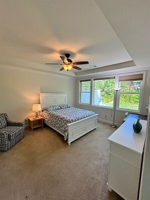A bedroom with a bed, a chair, a desk, a ceiling fan, and a window. - Coastal Club * 3br Twin House w 2.5 Baths (Lewes)