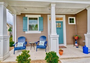 A porch with two blue chairs, a small table, and a potted plant. - Coastal Club * 3 BR Luxury Villa Twin House (Lewes)