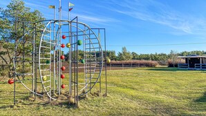 A playground structure with climbing elements and a small building in the background. - Nice home in Visby with WiFi (Visby)