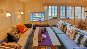 A cozy living room with a sofa, a coffee table, and a flat-screen TV displaying various streaming services. - Awesome home in Hemsedal with WiFi (Hemsedal)