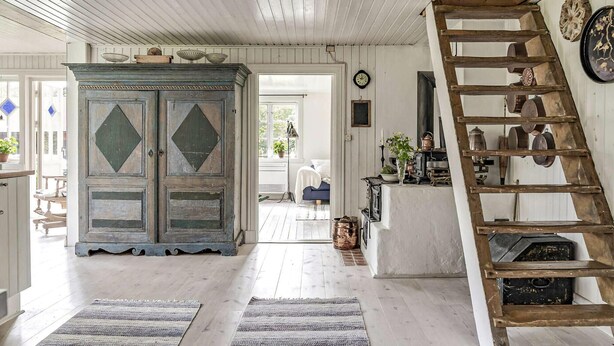 A rustic interior with a wooden ladder, a vintage cabinet, and a staircase. - 4 bedroom cozy home in Ellös (Ellös)