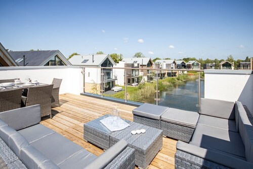 A contemporary glass fronted lake side home that sleeps 8 guests  in 4 bedrooms