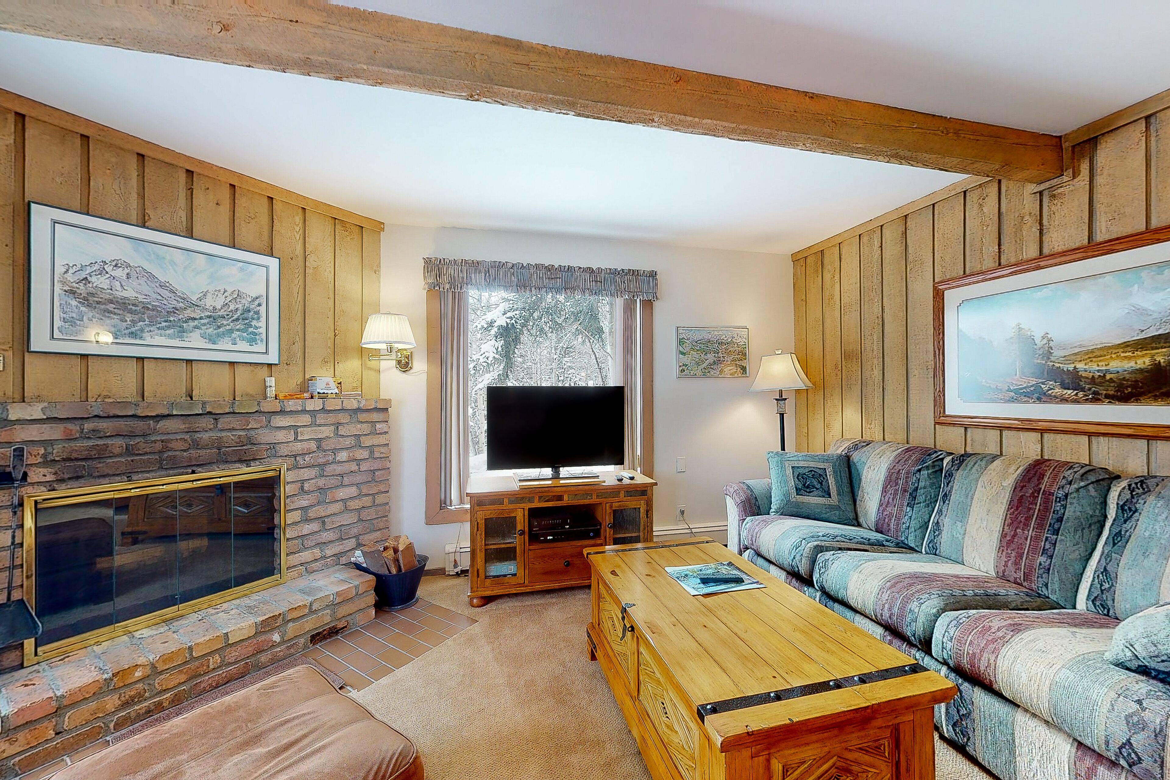 Mountain-view condo with wood-burning fireplace & deck - walk to village