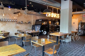 Enjoy casual dining in a rustic, industrial setting with wooden tables and a vintage vibe.