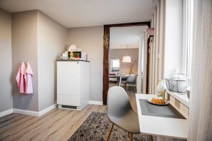 Cozy retreat with a compact kitchenette, dining area, and comfortable seating.