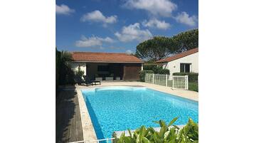 A heated pool, sun loungers