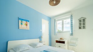 A bedroom with a bed, a nightstand, a dresser, a window with curtains, and a wall-mounted shelf. - House in the south of France with private pool (Roquebrun)