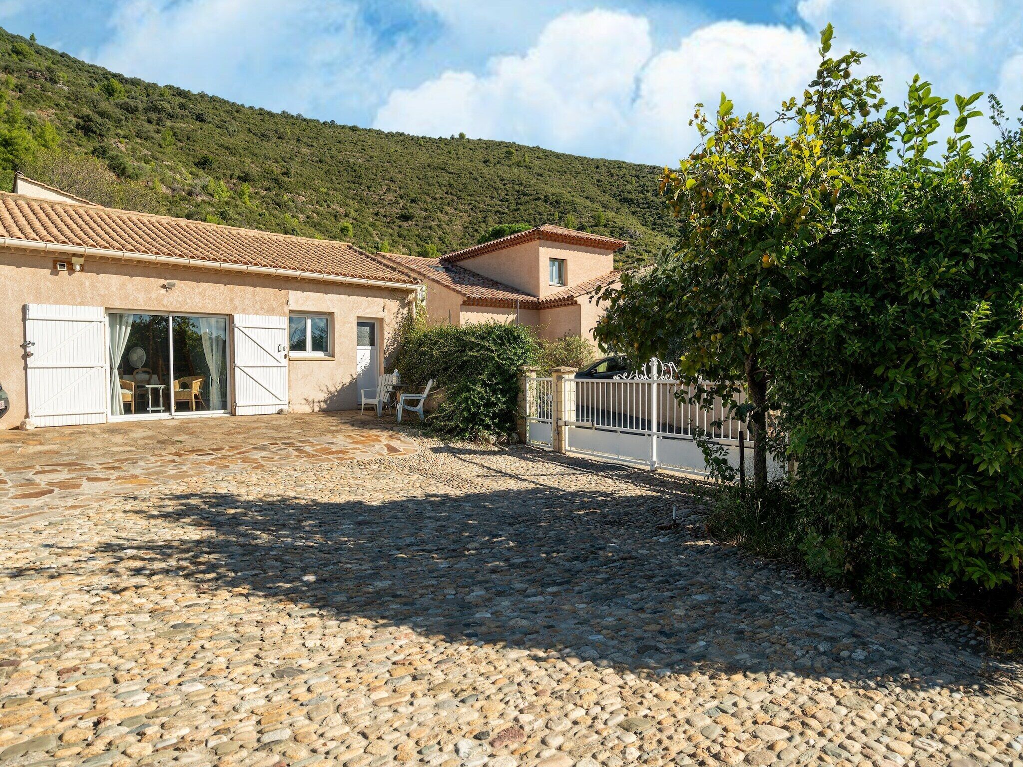 A building with a tiled roof and a stone-paved courtyard.