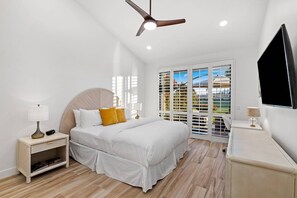 A bedroom with a bed, bedside tables, a ceiling fan, and a TV. - Modern & Relaxing Condo | Stunning Fairway and Mountain Views | Ideal Vacation Retreat (Palm Desert)