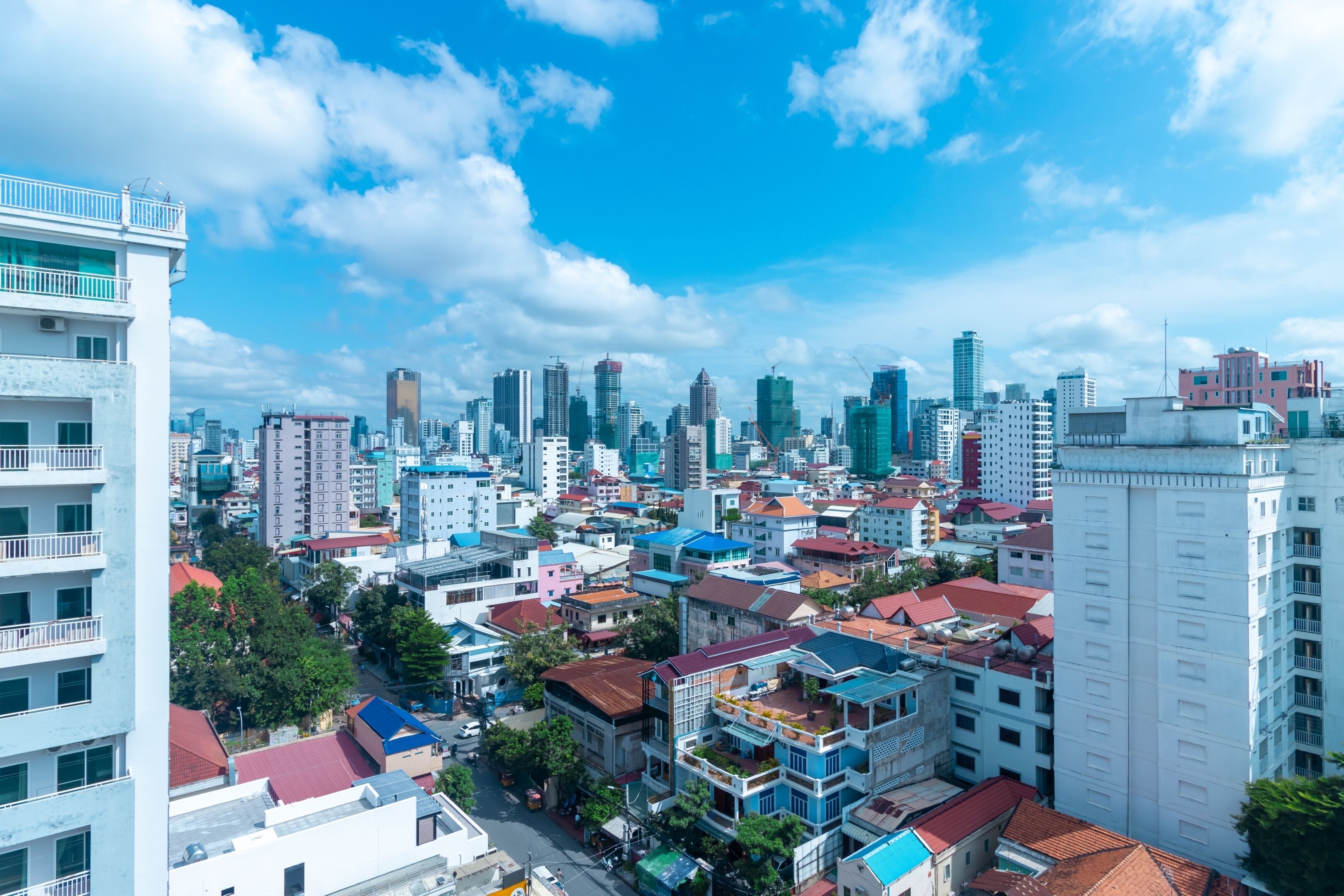 A cityscape with a variety of building heights and architectural styles, including modern high-rises and traditional structures.