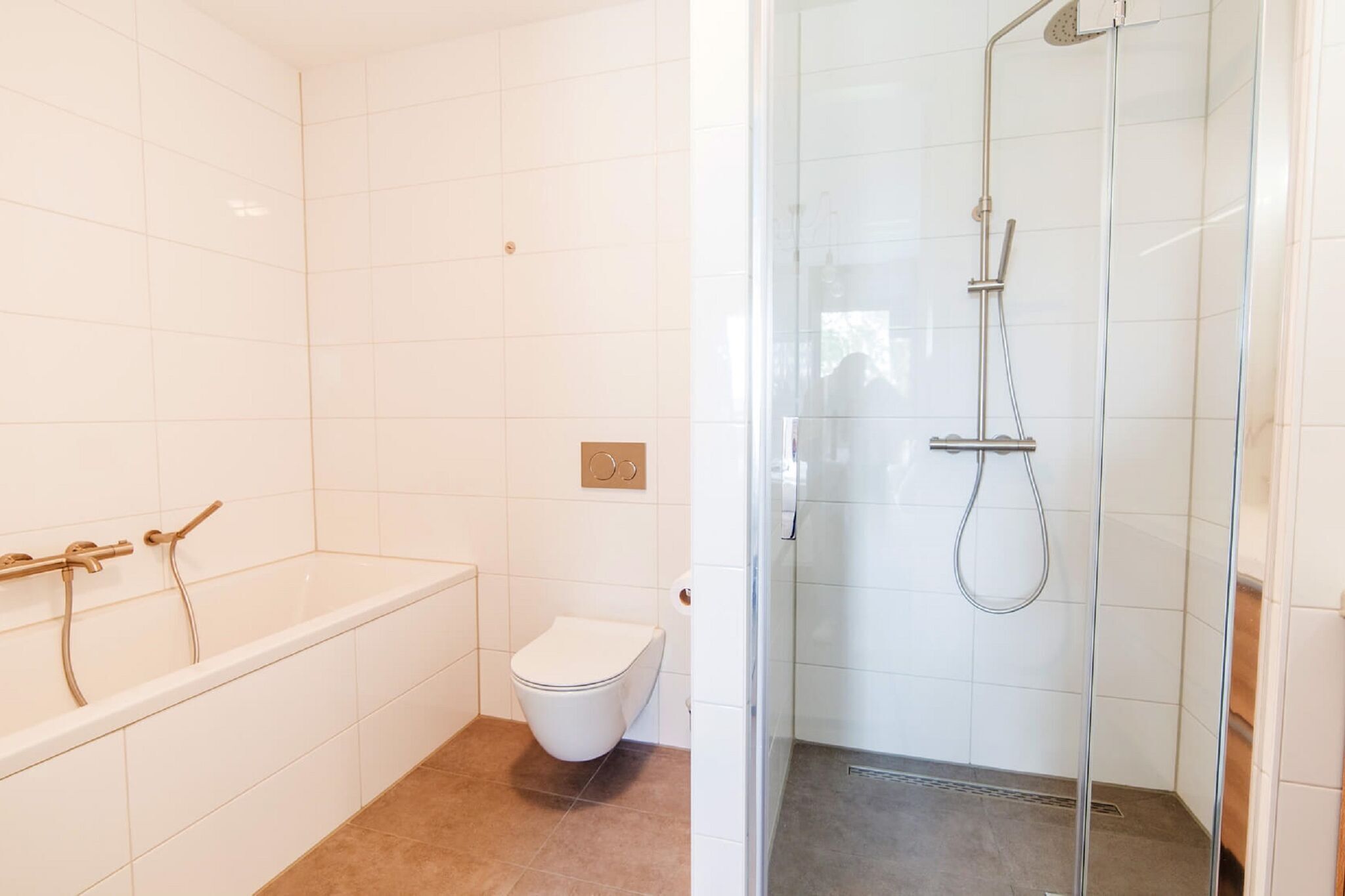 Ein Badezimmer mit Badewanne, Toilette und einer Duschkabine.