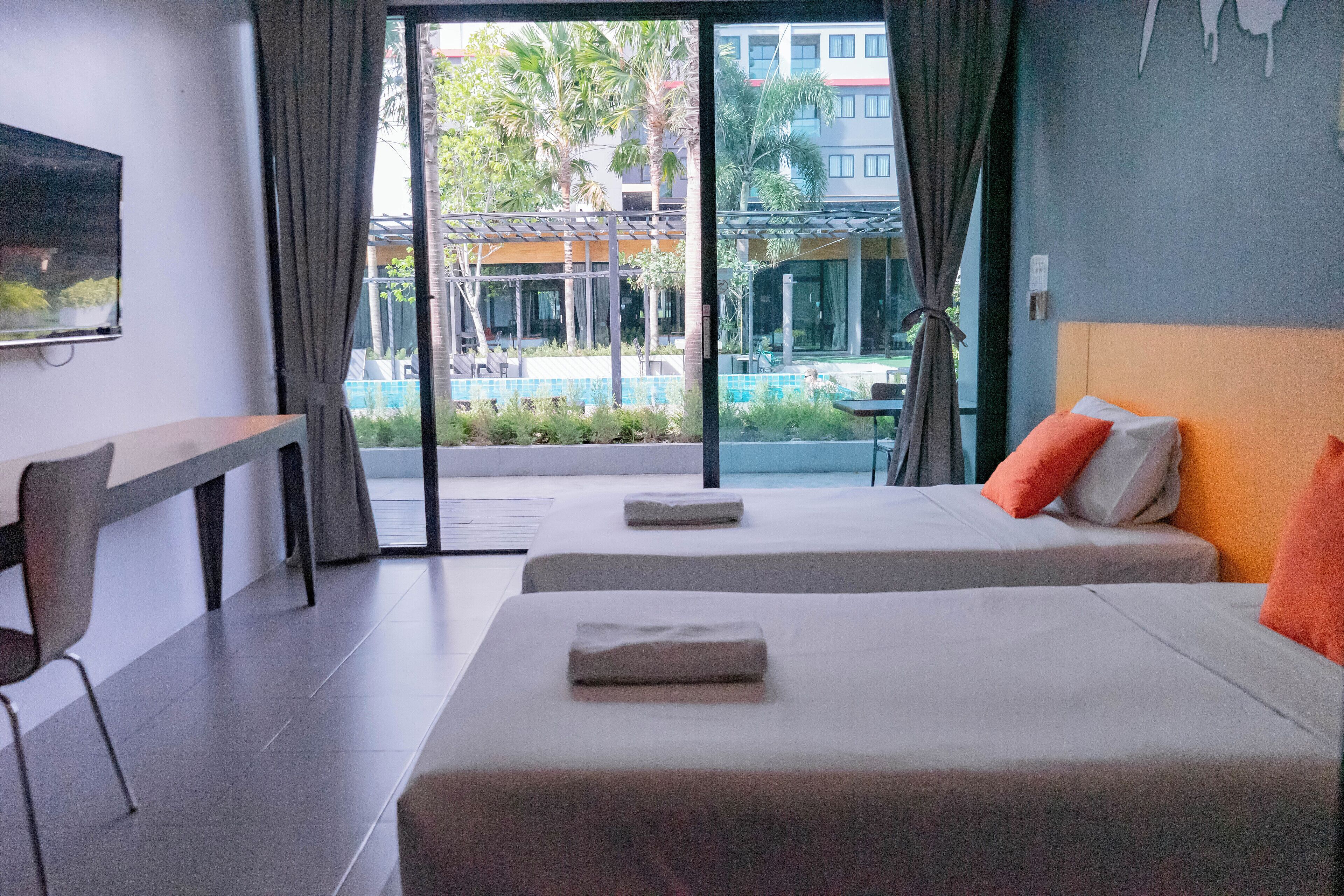 Deluxe Twin Room with Pool View | Individually decorated, desk, laptop workspace, blackout curtains