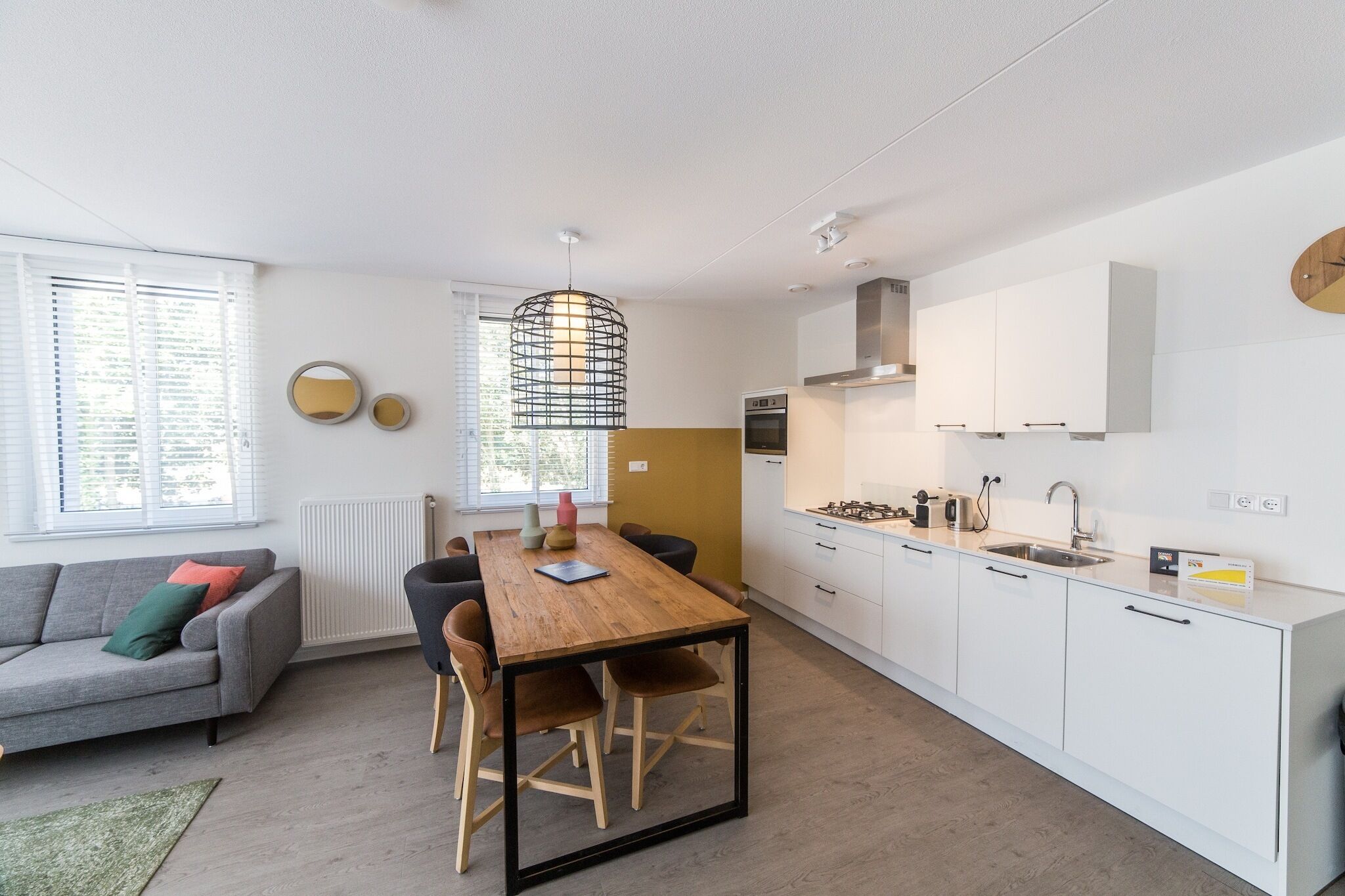 A modern apartment with a kitchen, dining area, and living space.