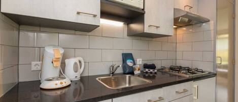 Fridge, microwave, stovetop, coffee/tea maker