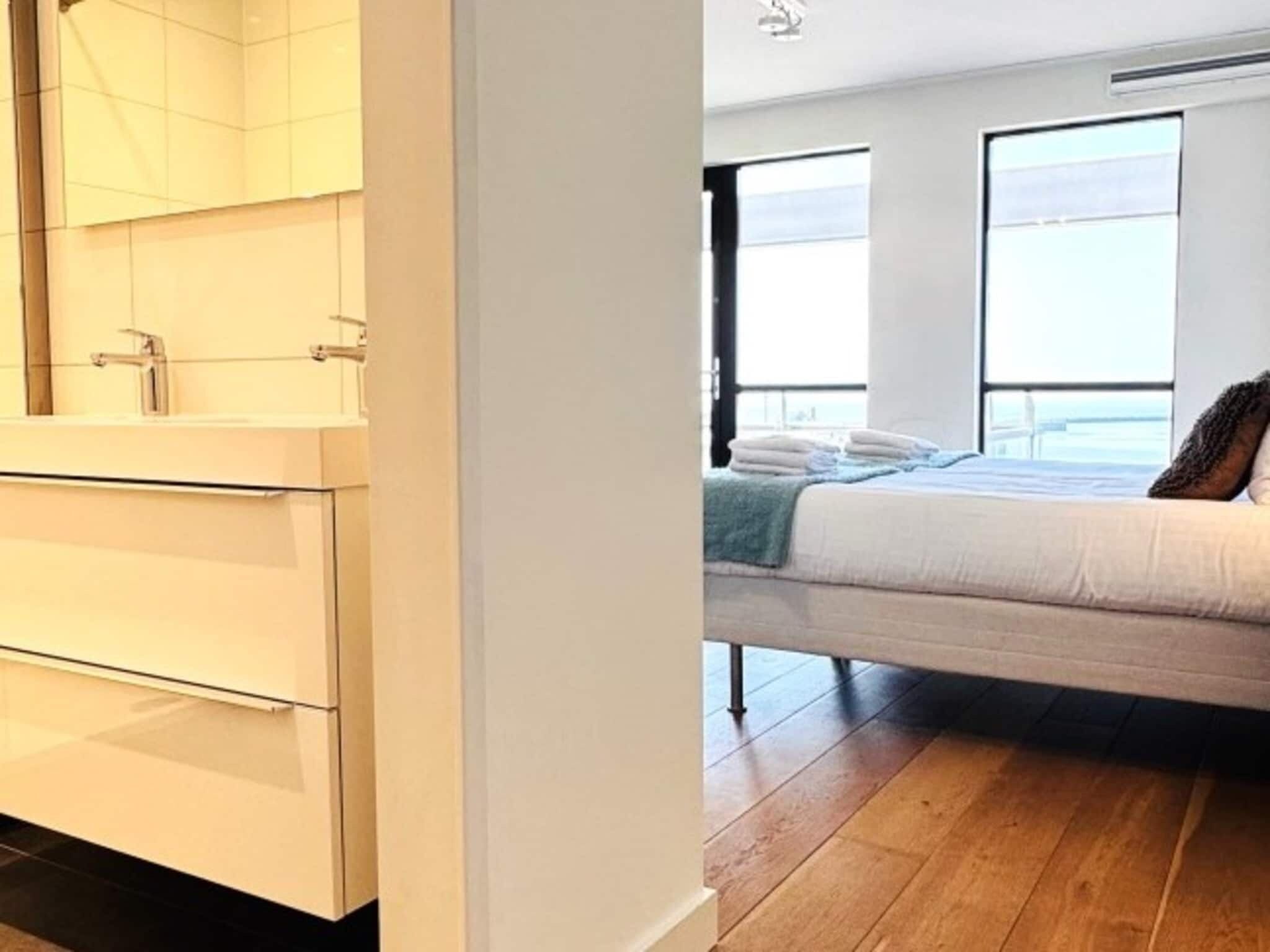 A bedroom with a bed, a window, and a view of the outdoors.
