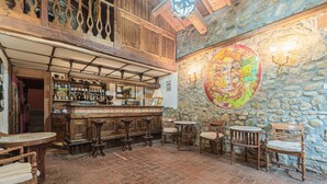 A rustic bar area with wooden furniture, a stone wall, and a large map mural. - Holiday Home in Ficulle with Pool Access (Ficulle)