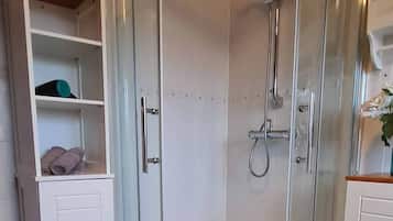 Bathtub, hair dryer, towels, toilet paper