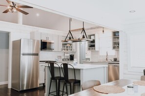 Enjoy cooking in this well-equipped kitchen with a refrigerator, oven, and microwave. The kitchen island offers additional seating and a dining area.