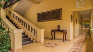 A staircase with a handrail, a patterned floor, and a framed picture on the wall. - Marirath Boutique Hotel  (Siem Reap)