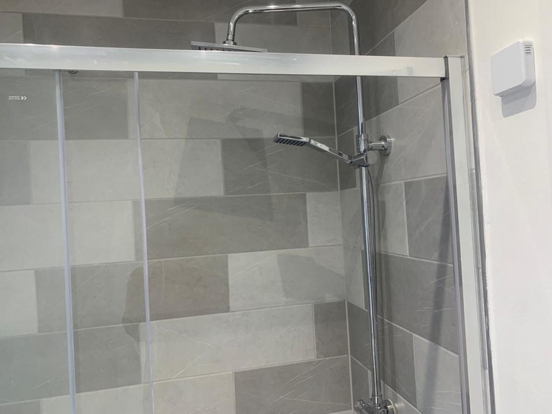 Separate bathtub and shower, deep-soaking bathtub, towels