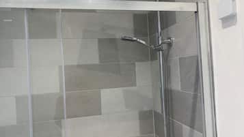 Separate bathtub and shower, deep-soaking bathtub, towels