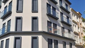 A modern multi-story building with balconies and large windows. - Bright 1BR Corner Apt, 3 Balconies, Central Málaga - Ideal for Work & Leisure (Málaga)