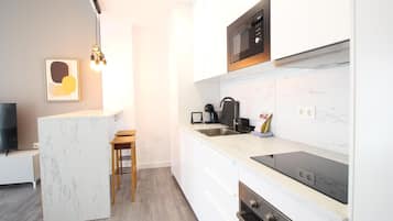 Frigorífico, microondas, cafetera o tetera y mesa de comedor