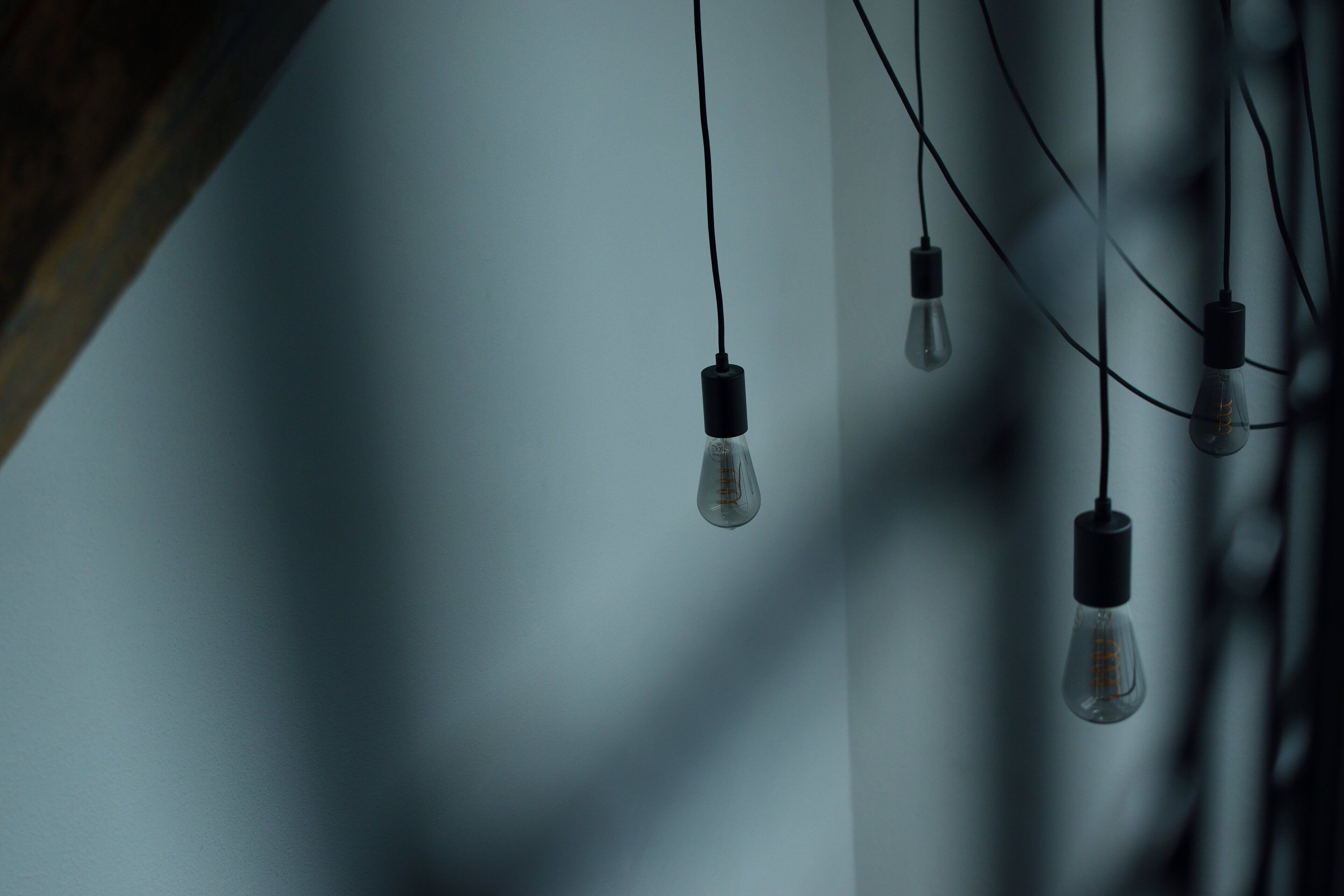 A ceiling with multiple hanging light bulbs.