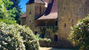 A historic stone building with multiple towers and a central courtyard.