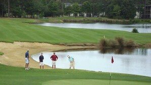 A golf course with a water hazard and players. - Nice Condo, Partial Ocean Views, Pool-307 Litchfield Retreat (Pawleys Island)
