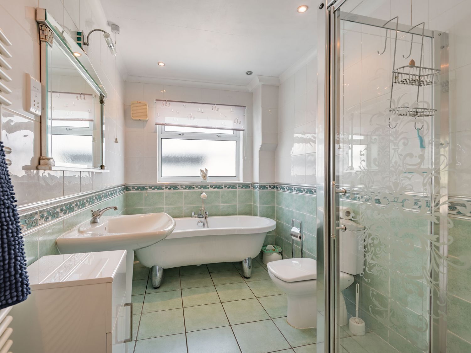 A bathroom with a freestanding bathtub, a sink, and a toilet.