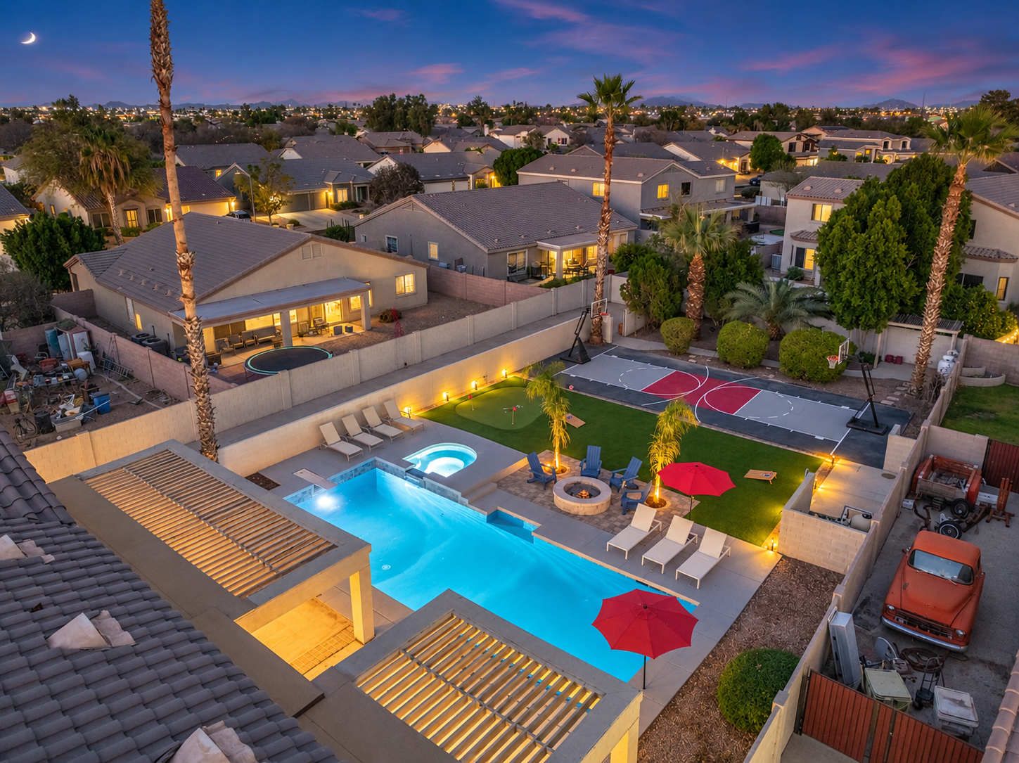 From above, the lit-up pool, hot tub, and fire pit look great at night.