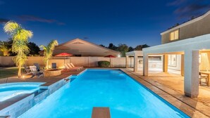 A swimming pool with steps, outdoor seating, and a covered area with umbrellas. - The Cardinal | Ultimate Group Retreat in Glendale (Glendale)