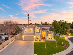 At sunset, the front of the home glows under a pink sky. - The Cardinal | Ultimate Group Retreat in Glendale (Glendale)