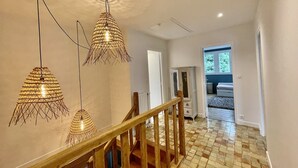 A staircase with wooden railings and a checkered floor. - Renovated country property with fireplace, near forest (Le Mont-Saint-Adrien)