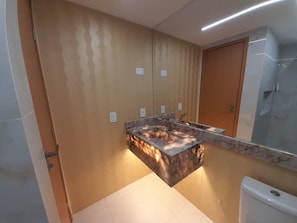 A bathroom with a marble sink, a mirror, and a shower. - Amaranth Beach Class (Cabedelo)