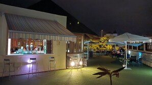 An outdoor bar area with seating, a pool, and umbrellas. - El Mirador Los Cristianos, 20 sqm terrace and incredible 40 sqm roof terrace (CN)
