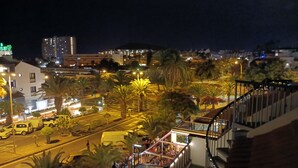 A nighttime cityscape with palm trees, streetlights, and buildings. - El Mirador Los Cristianos, 20 sqm terrace and incredible 40 sqm roof terrace (CN)