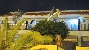 A building with a white facade, a red-tiled roof, and a staircase leading to an upper level. - El Mirador Los Cristianos, 20 sqm terrace and incredible 40 sqm roof terrace (CN)