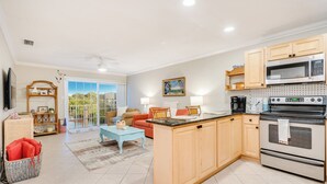 A modern kitchen with wooden cabinets, a built-in oven, and a central island.