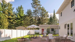 A backyard with a patio, outdoor furniture, a grill, and a white fence. - Amazing Family Retreat w/ Fenced Yard & BBQ! (Stevens Point)