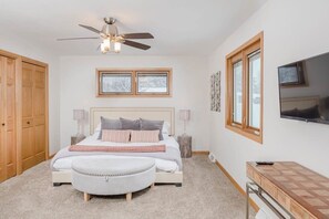 A bedroom with a bed, a ceiling fan, a TV, a window, and a wardrobe. - Amazing Family Retreat w/ Fenced Yard & BBQ! (Stevens Point)