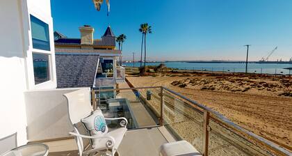 Coastal-themed beachfront home with water views, grill, & beach access