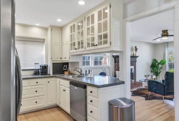 Kitchen features stainless steel appliances, a central island, and a sink with a faucet.