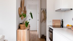 A modern kitchen with white cabinets, a wooden countertop, and a potted plant. - 2 bedroom nice home in Den Oever (Den Oever)