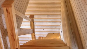 A wooden staircase in a log cabin interior. - Gorgeous home in Jezierzany with sauna (Jezierzany)