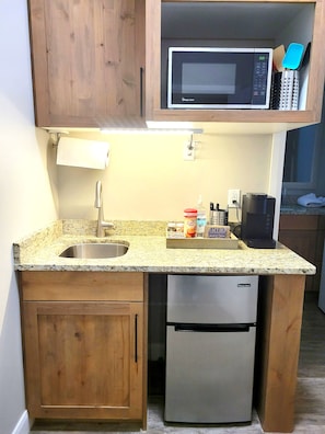 Enjoy cooking in this well-equipped kitchen with a microwave, refrigerator, and ample workspace.