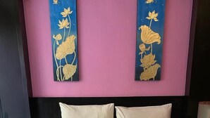 A hotel room with a large bed, two pillows, and a decorative swan towel arrangement. - Lavender Patong Hotel (Patong)
