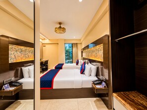 A hotel room with a large bed, bedside tables, a desk, and a view of the outdoors. -  Zip By Spree Hotels Surat (Surat)